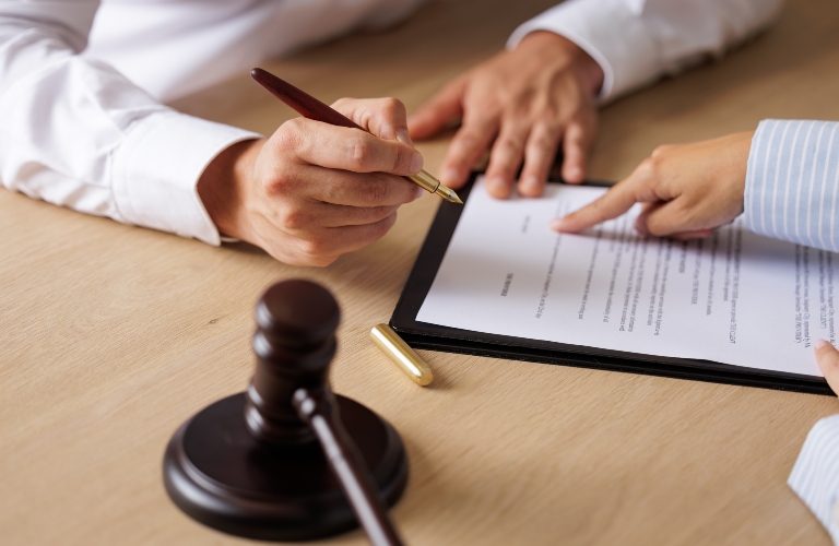 lawyer shows client where to sign documents