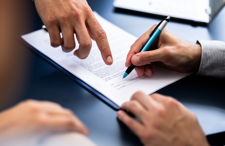 lawyer shows client where to sign